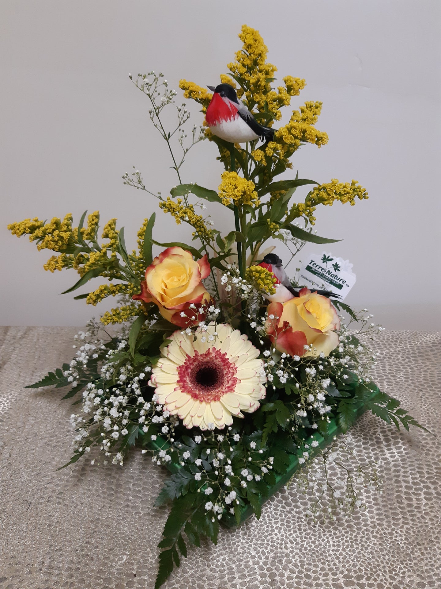 Arrangement floral avec Solidagos, Gerberas et Roses