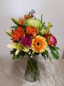 Bouquet dans les tons d'orange, fuchsia et jaune