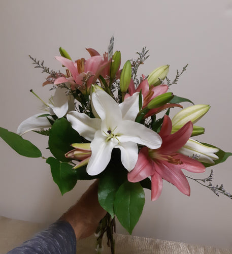 Bouquet de fleurs attachées et emballées avec Lys roses et blancs